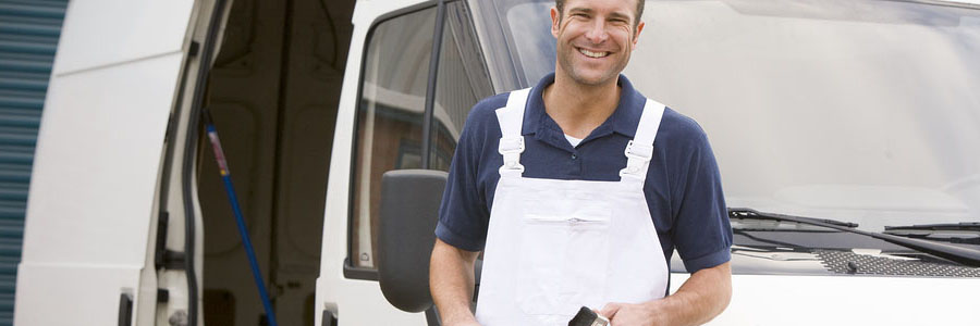 Painter standing with van smiling